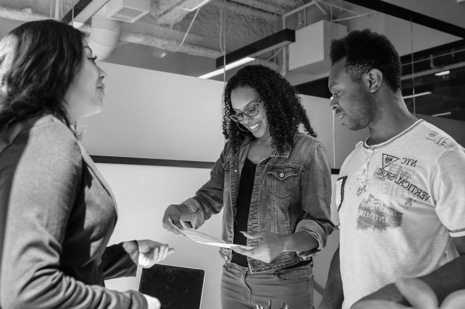 Event planning team reviewing venue layouts and technical requirements